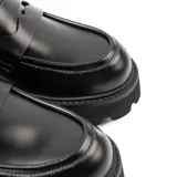 Zapato tipo mocasín de cuero sintético color negro, con plataforma y taco track.