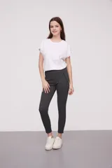 Calza negra de tiro alto con cierre lateral y detalle de costura en la rodilla.