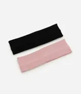 Kit de dos vinchas para el pelo confeccionadas en poliéster con textura acanalada, en color negro y rosado.