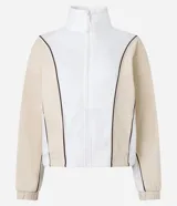 Campera deportiva de cuello alto con cierre frontal completo. Presenta un diseño bicolor en blanco y beige con líneas curvas en negro que definen la silueta. Confeccionada en una mezcla de poliéster, modal y elastano.