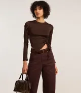 Pantalón wide leg color crudo confeccionado en sarga con pespuntes contrastantes, cintura alta con trabillas, cierre por botón y cremallera, bolsillos delanteros y traseros.