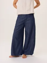 Pantalon de jean de corte ancho y holgado, con diseño de tiro medio y costuras reforzadas en contraste. Presenta una silueta fluida desde la cadera hasta el ruedo.