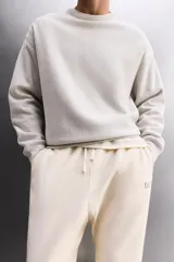 Sudadera negra de entrenamiento relaxed fit confeccionada en tejido de algodón con interior rizo, cuello redondo, manga larga y acabados en rib.