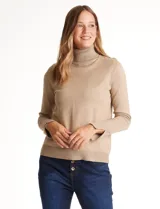 Polera de tejido fino con cuello alto, manga larga y detalle de tajo en los puños.