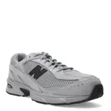 Championes urbanos New Balance modelo 509, color gris, confeccionados en una combinación de malla y gamuza. Presentan el logo 'N' en color negro en los laterales y suela con tecnología ABZORB para mayor amortiguación.