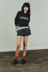 Sudadera negra de cuello redondo y manga larga, con texto blanco "SCREENWRITER & MAIN CHARACTER" en el delantero. Acabados en rib a tono.