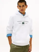 Buzo canguro blanco de puro algodón con capucha ajustable, bolsillo frontal tipo karkur y logo de Tommy Hilfiger estampado en el pecho con detalles en verde.