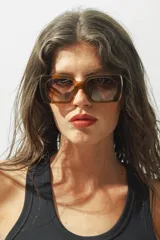 Lentes de sol con montura gruesa color marrón y lentes degradadas.