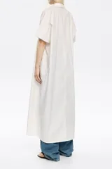 Vestido largo blanco de algodón, corte oversize, con cuello camisero, manga corta recta y cierre frontal con botones.