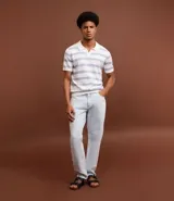 Pantalón de jeans celeste, corte slim, con bolsillos delanteros y traseros, trabillas en la cintura y cierre tradicional con botón y cremallera.