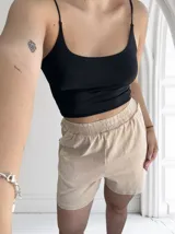 Short color beige con efecto lavado, cintura elastizada y bolsillos laterales.