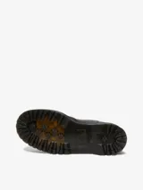 Bota Chelsea negra de cuero con refuerzos elásticos laterales, plataforma de 4 cm y suela tipo comando con cámara de aire. Presenta costuras amarillas en la vira Goodyear y una tira de tela amarilla con el logo "AirWair" en la parte trasera.