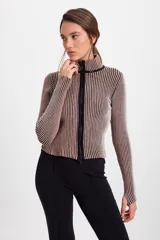 Campera corta de tejido de punto acanalado con cuello alto y cierre frontal completo. Presenta un diseño de rayas verticales en dos tonos que generan un efecto visual tornasolado.