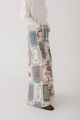 Pantalón jean wide leg con estampado de cartas de póker y dados.