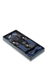 Set de tirantes, moña y pañuelo de bolsillo color rojo con diseño floral. Los tirantes son ajustables y tienen apliques para abrochar a botones o pinzas metálicas para sujetar al pantalón.