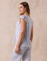 Conjunto de pijama marca René Rofé, compuesto por una remera de escote en V con botones y un pantalón capri con cintura elastizada, ambos en tejido soft estampado con motivos florales en tonos celeste y blanco.