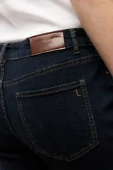 Jean bootcut de tiro medio en color azul oscuro, con diseño clásico de cinco bolsillos y cierre frontal con botón y cremallera.