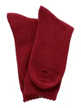 Medias de largo medio en color bordó, confeccionadas en tejido grueso con puño suave y detalle de etiqueta con logo en la parte superior.