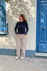 Remera de manga larga color azul marino, con cuello redondo y puños decorados con volados sutiles.