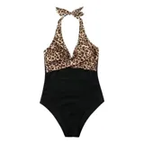 Malla entera de color verde oscuro, combinada con un diseño floreado en la parte inferior. Presenta escote halter cruzado y fruncidos en la zona del abdomen.