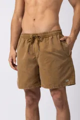 Short de baño de corte relajado en color gris azulado con efecto lavado. Cuenta con cintura elastizada con cordón ajustable, bolsillos laterales y una pequeña etiqueta decorativa en el ruedo.