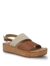 Sandalias de plataforma con suela de corcho. Presentan una tira frontal de cuero marrón y una tira superior de tela en color beige, con ajuste de hebilla metálica en el talón.