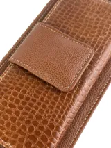 Billetera porta celular de cuero color marrón, con textura combinada de efecto croco y cuero liso. Cuenta con cierre principal y bolsillo frontal con solapa y broche magnético.