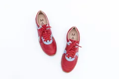 Zapatillas Magnolia de cuero negro con detalles en blanco y suela marrón.