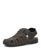 Sandalias de cuero color marrón oscuro con diseño tipo huarache o romano, costuras visibles en tono contrastante y cierre con tira ajustable de velcro en el empeine.