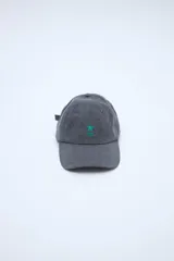 Gorra gris de lona con visera curva y pequeño bordado verde en el frente que incluye una estrella y dos líneas horizontales.
