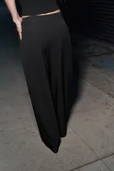 Pantalón de corte ancho y tiro bajo, con trabillas en la cintura, bolsillos laterales y falsos bolsillos traseros. Cuenta con cierre frontal de cremallera, botón interior y gancho metálico.