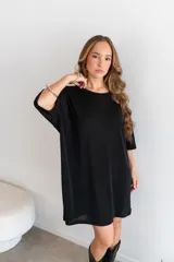 Remerón negro de manga corta, corte oversize y largo por encima de la rodilla.