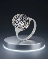 Anillo de plata y oro de diseño ovalado, con detalles grabados y filigrana en relieve en la parte superior.