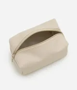 Kit de tres neceseres de diferentes tamaños en color beige. Incluye un neceser grande transparente con manijas, un neceser mediano transparente y un neceser pequeño opaco con textura, todos con cierre de cremallera.