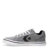 Championes Converse modelo Distrito de caña baja, confeccionados en lona color gris. Presentan el icónico logo de estrella y chevron en negro en el lateral, cordones blancos y suela de goma blanca con una línea negra decorativa.