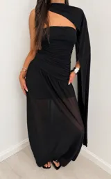 Vestido largo negro de diseño elegante, con cuerpo drapeado estilo strapless, falda larga con capa exterior transparente y estola o bufanda integrada al cuello.
