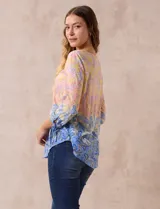 Blusa de modal estampada con cuello redondo y escote en V con aplique metálico. Mangas 3/4 con lazo.
