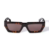 Lentes de sol Off-White modelo Manchester, con armazón grueso de acetato en color carey (havana) y cristales oscuros. Presentan un diseño angular y moderno, con el logo de la marca en blanco en las patillas.