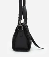 Cartera satchel Satinato de color negro, confeccionada en poliuretano. Cuenta con asas de mano fijas, correa larga removible, bolsillos frontales con cierre, tachas metálicas decorativas y tiras colgantes.