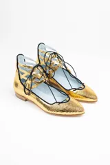 Botines dorados con estampado de escamas, con cordones negros y detalles calados.