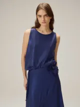 Top negro sin mangas con estampado geométrico y manchas texturizadas en tonos marrones y beige, con silueta balloon.