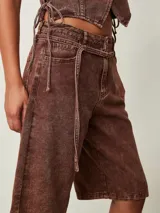 Bermuda de denim con efecto acid wash en color marrón chocolate, de tiro medio y corte holgado hasta las rodillas.
