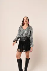 Blusa azul marino con estampado de hojas doradas, escote en V y mangas largas acampanadas.