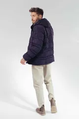 Campera puffer acolchada de color azul marino, con capucha ajustable, cierre frontal y bolsillos laterales. Diseño de corte recto y acabado mate.