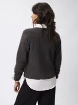 Sweater de tejido acanalado con cuello redondo y manga larga. Presenta un corte relajado y textura estructurada.