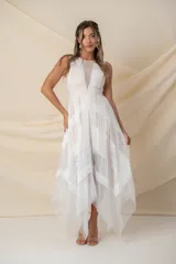 Vestido midi de tul color blanco con aplicaciones de encaje en festones, diseño sin mangas con escote en V y falda de corte irregular.