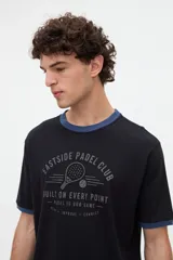 Remera negra de manga corta con cuello redondo y puños en contraste de color azul, con estampa frontal temática de pádel.