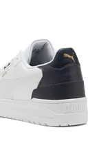 Championes Puma Shuffle Downtown, color blanco con detalles en negro y dorado.