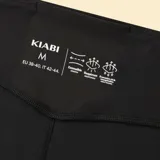 Legging deportivo de corte flare, color negro, con cintura alta y diseño ajustado en la parte superior que se ensancha hacia el ruedo.
