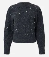 Buzo de tricot texturizado color gris con perlas blancas aplicadas. Tiene mangas largas abullonadas y cuello redondo.
